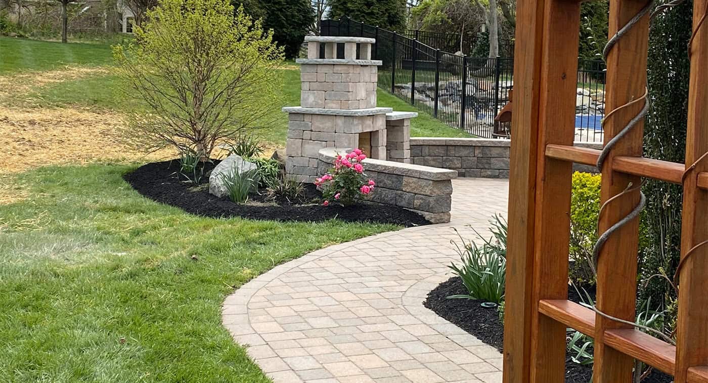 Paver-Fireplace-Kit-Patio-Design Modular paver fireplace kit installed on matching paver patio with walkway in West Chester