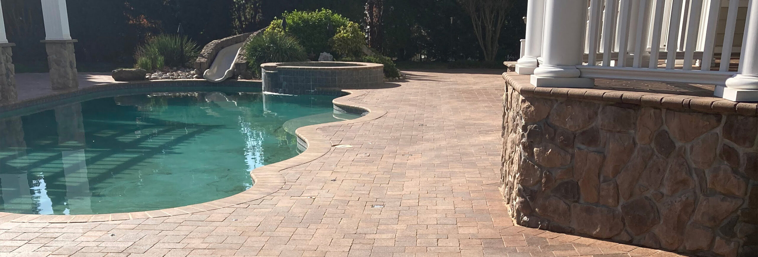 backyard patio with pool and waterslide from CKC Landscaping