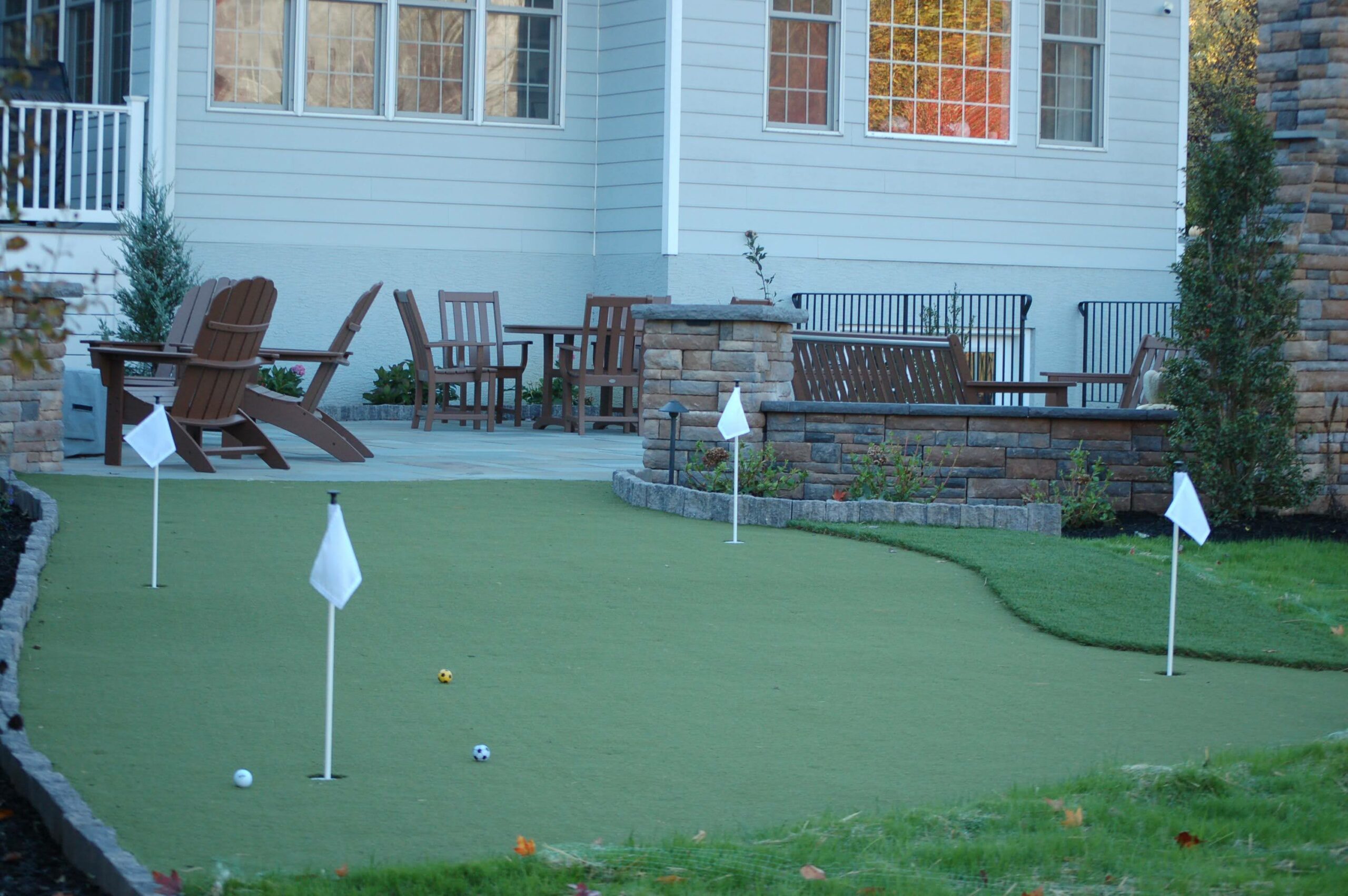 Artificial turf putting green in a backyard from CKC Landscaping