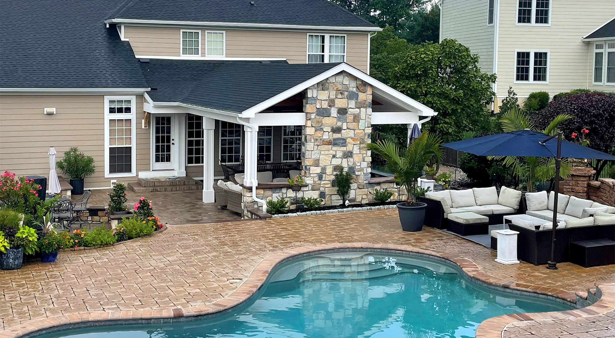 backyard with pool and two seating areas from CKC Landscaping