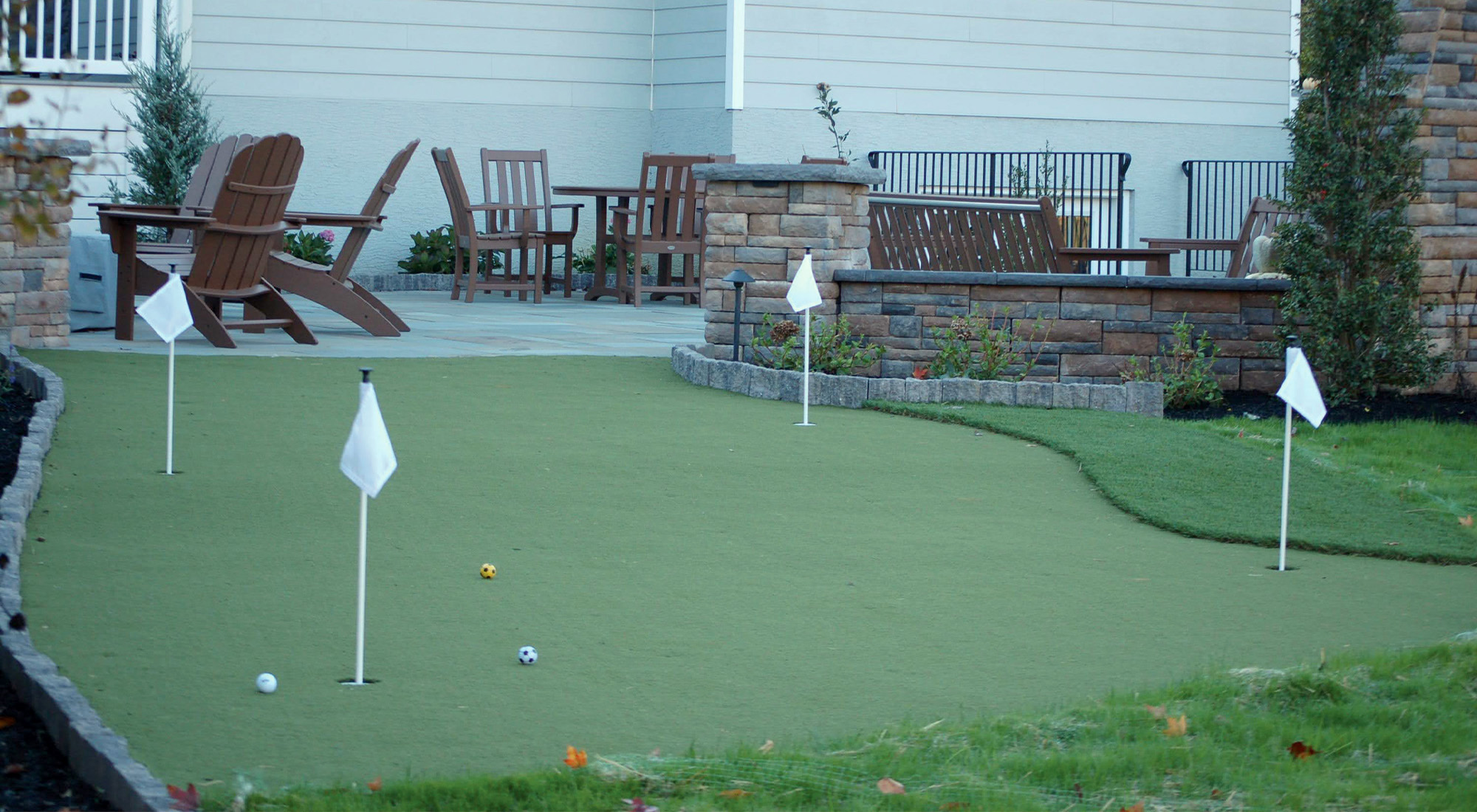Artificial turf putting green in a backyard from CKC Landscaping