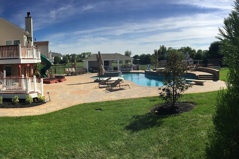 backyard with pool and two seating areas from CKC Landscaping