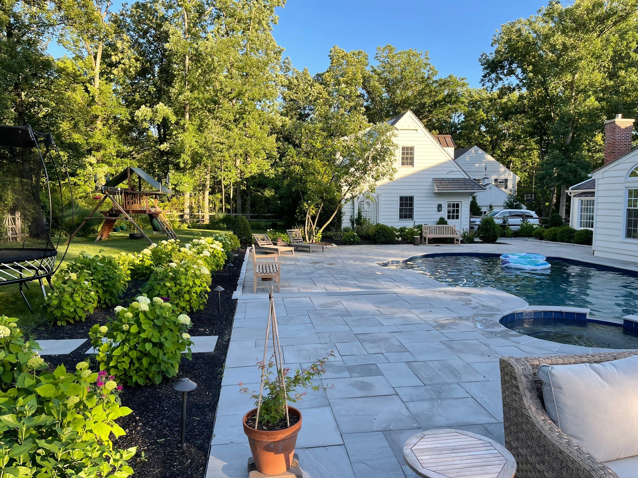 Natural flag stone pool patio designed and installed by CKC Landscaping