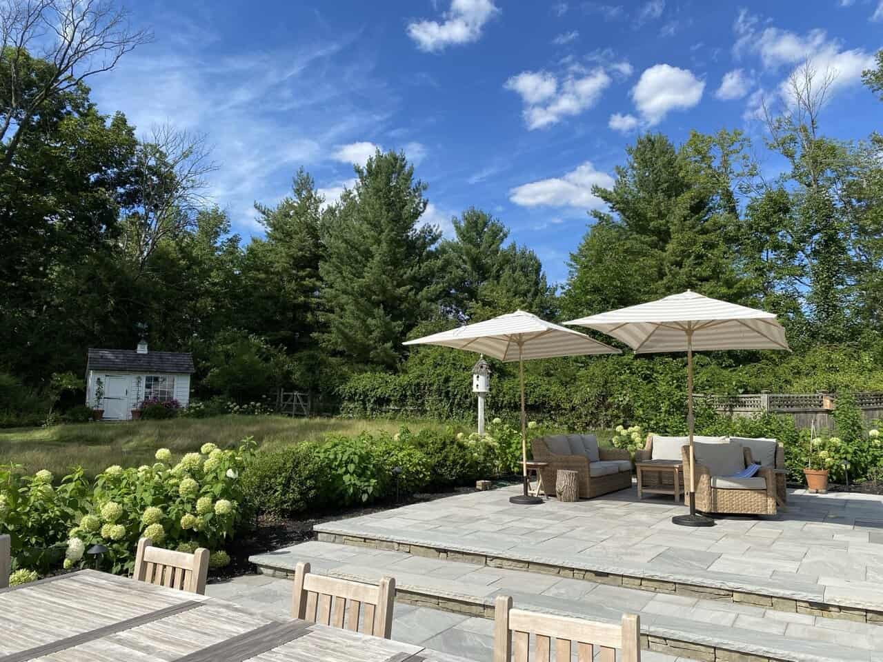 Pool-Deck-Hardscape-Collegeville Luxury pool deck renovation with travertine coping and privacy landscaping in a Collegeville backyard.