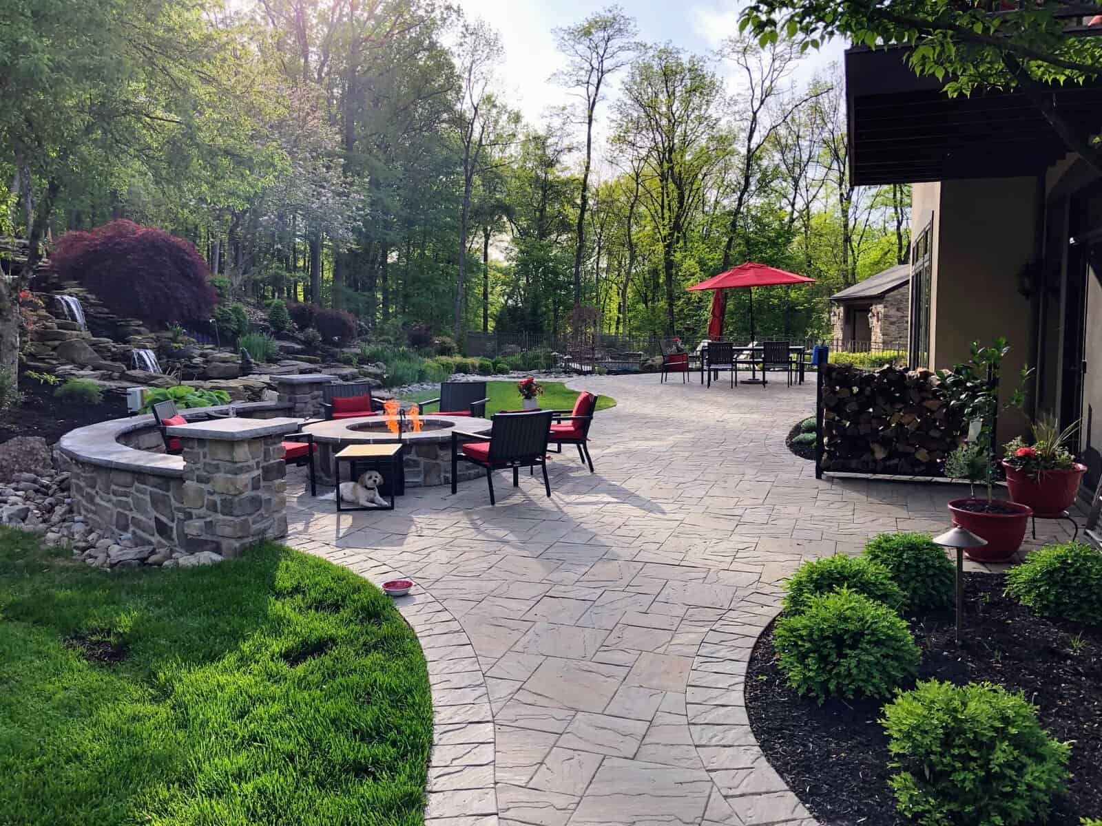 Backyard-Fire-Pit-Design-Exton Wood-burning stone fire pit with seating wall in Exton PA