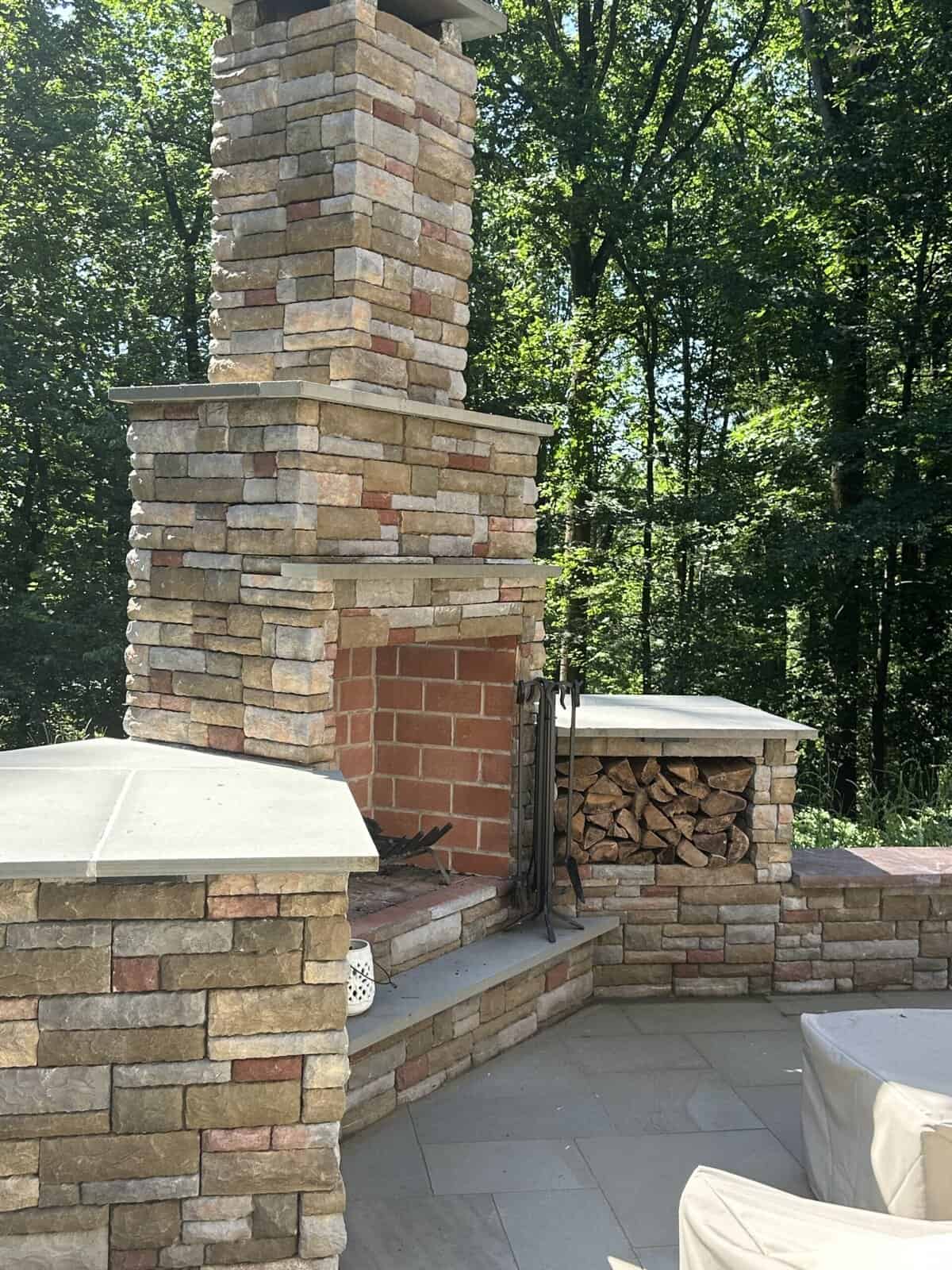 Cast-Stone-Fireplace-Wood-Storage Cast stone outdoor fireplace with built-in wood storage boxes and flagstone caps in West Chester