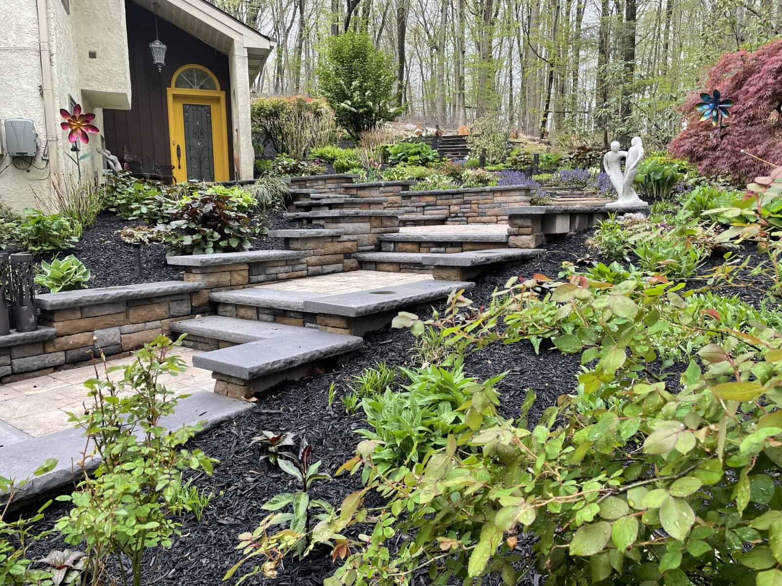 Retaining-Wall-Solution-Kennett-Square Large structural block wall and step system managing slope in Kennett Square backyard