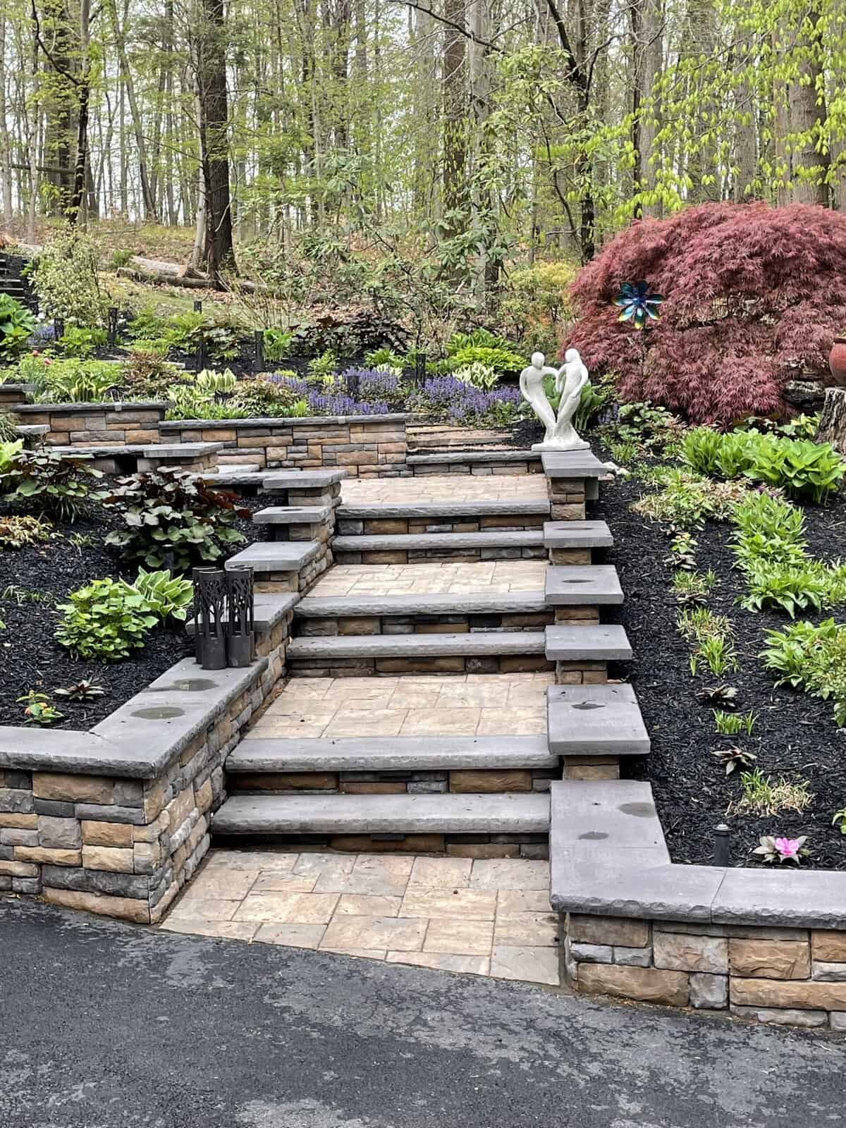 Belgard-Cast-Stone-Wall-Chester-Springs Boulder retaining wall managing slope on Chester Springs hillside property