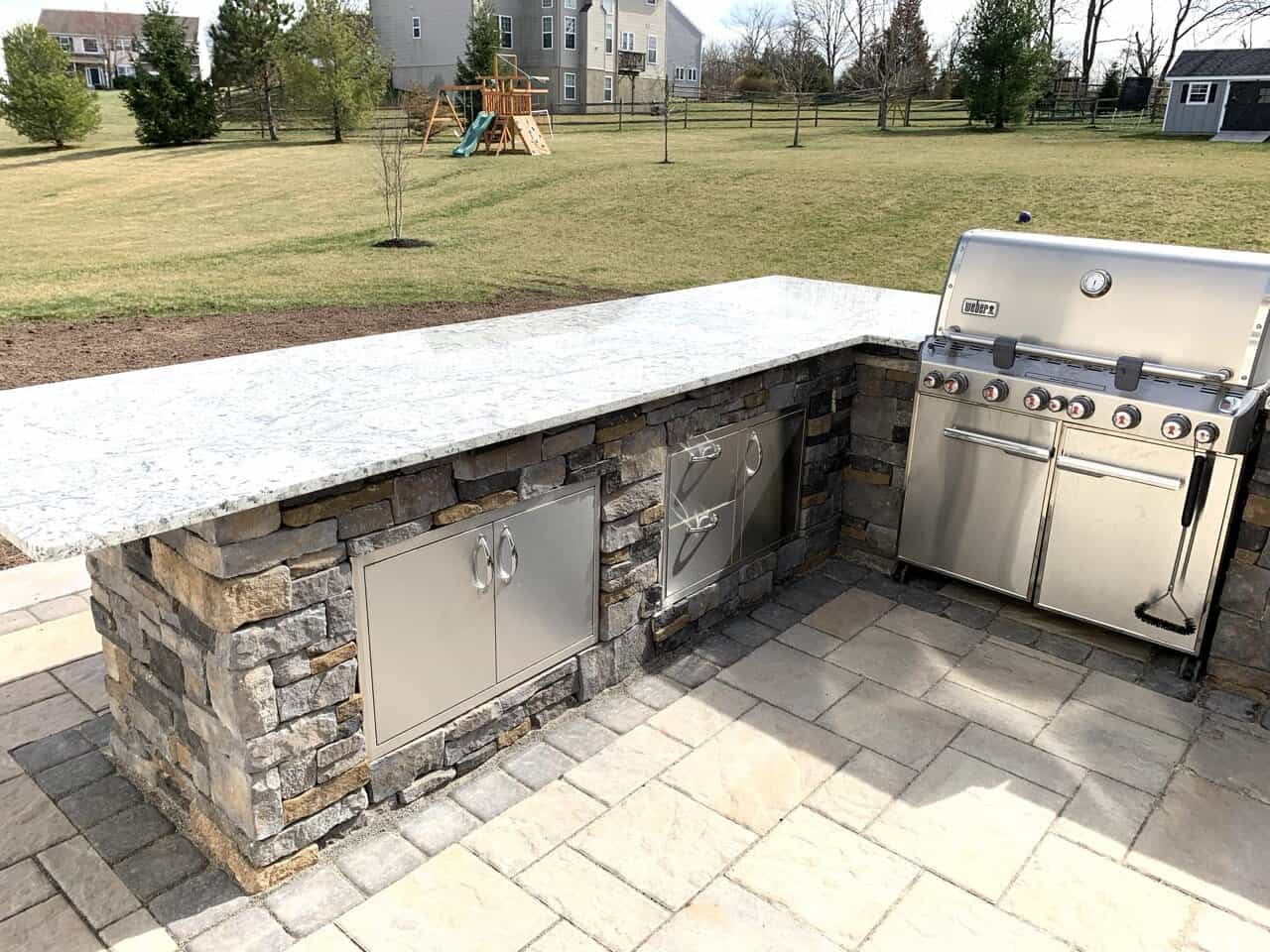 Custom-Outdoor-Kitchen-Radnor-PA Custom outdoor kitchen with built-in grill and stone veneer in Radnor PA.