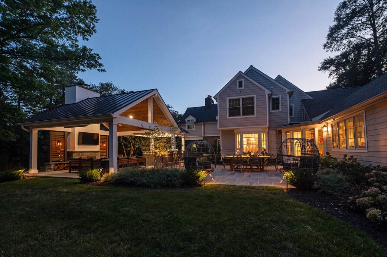 Covered outdoor living space with wet laid Pennsylvania flagstone patio and integrated LED lighting in West Chester