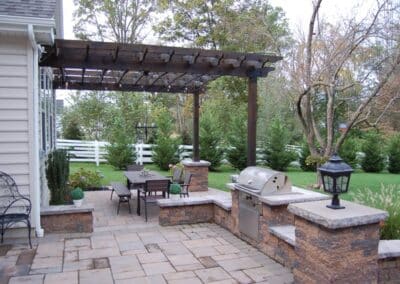 Custom wood pergola built over paver patio with outdoor dining area in Kennett Square PA