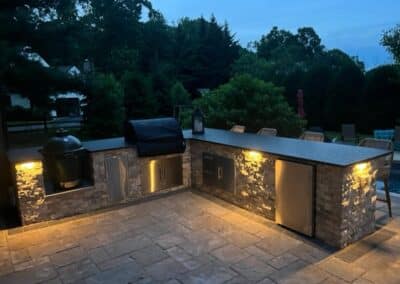 Illuminated backyard patio and garden path using low-voltage landscape lighting in Collegeville, PA."