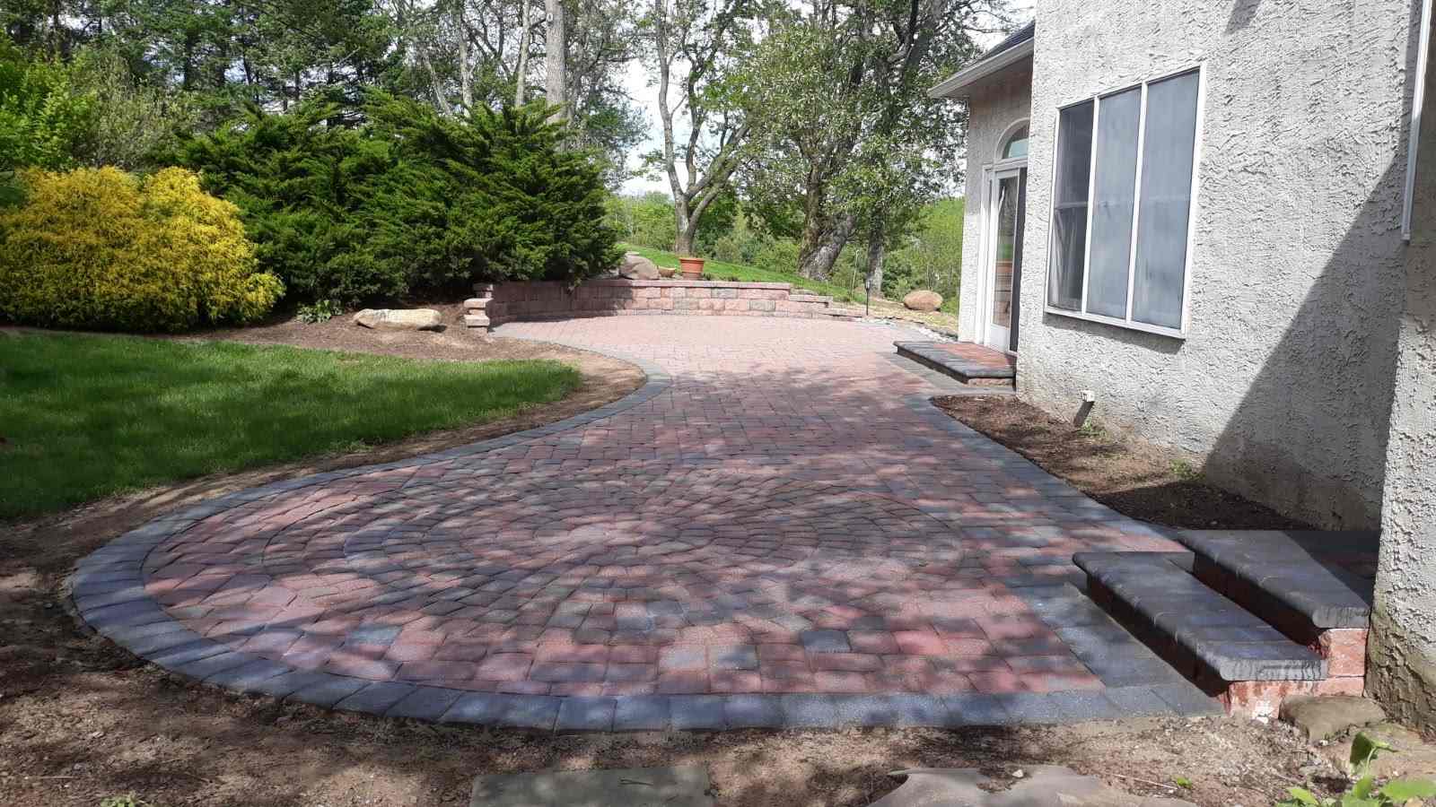 After paver patio restoration and enhancement in West Chester PA showing moss removal and joint sand replacement.