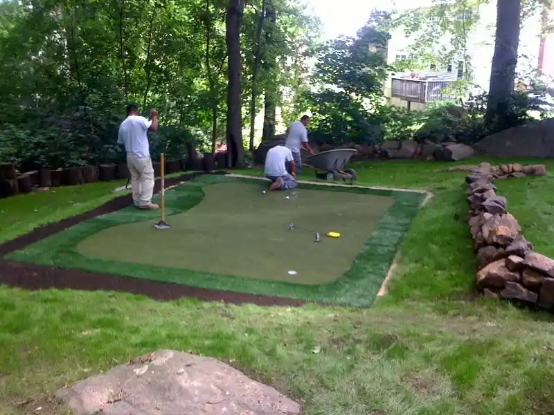 Artificial-Turf-Installation-Process-West-Chester.jpg CKC Landscaping team installing artificial turf base and drainage system in West Chester PA.