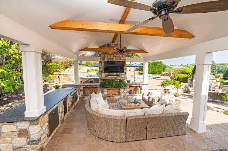 outdoor-kitchen-design-pa Outdoor kitchen with built-in gas grill and stone countertops.