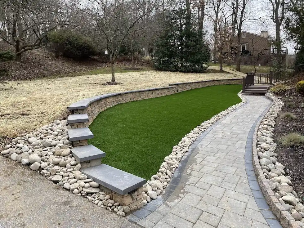 Artificial-Turf-Install-CKC-Landscaping Artificial Turf in Front of a Retaining Wall and paver walkway