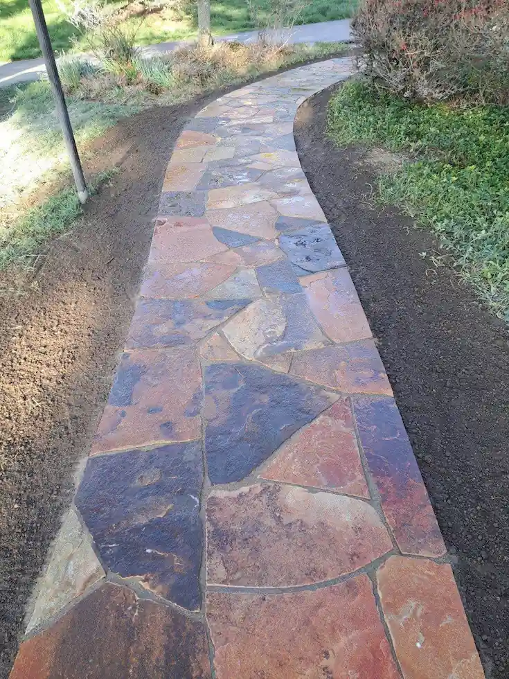 Irregular-Natural-Stone-Walkway-Hardscape-Chadds-Ford Natural irregular stone front walkway installation complementing a stone house in Chadds Ford PA
